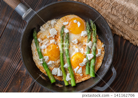 Rustic Breakfast Skillet With Fried Eggs Asparagus And Feta Cheese Rustic Breakfast Skillet With Fried Eggs Asparagus And Feta Cheese 141162706