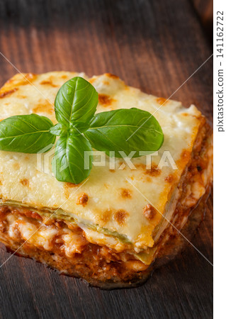 Traditional Lasagna Bolognese Slice Served On Dark Rustic Wooden Board Traditional Lasagna Bolognese Slice Served On Dark Rustic Wooden Board 141162722