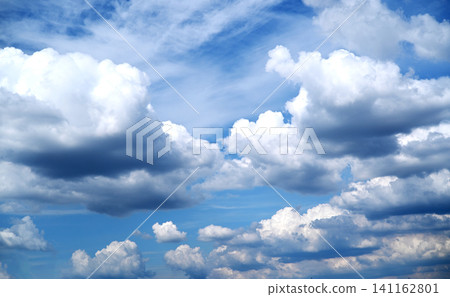 Beautiful blue sky with fluffy white cumulus clouds and light wispy cirrus on a sunny day. Beautiful blue sky with fluffy white cumulus clouds and light wispy cirrus on a sunny day. 141162801