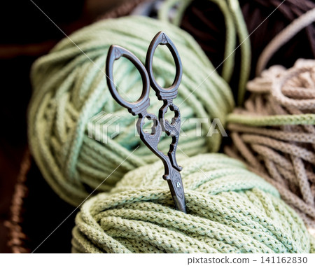 Ball of yarn on the table. Material for knitting. Ball of yarn on the table. Material for knitting. 141162830