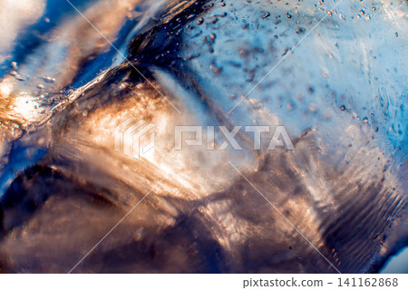 Beautiful abstract background. Ice close-up. The play of light. 141162868