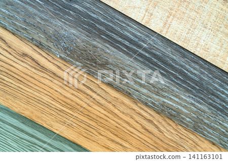 Vinyl tiles stack sample collection for interior designer. New wooden pattern vinyl tile. Full frame vinyl flooring material. Polymer vinyl sheet set for new home floor. Green, brown, and gray PVC. 141163101