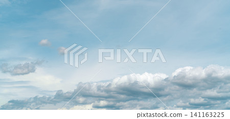 Panorama view of white fluffy clouds on blue sky. Close-up white cumulus clouds texture background. White puffy cloudscape. Beauty in nature. Soft-touch feeling like cotton. Beautiful cloudscape. Panorama view of white fluffy clouds on blue sky. Close-up white cumulus clouds texture background. White puffy cloudscape. Beauty in nature. Soft-touch feeling like cotton. Beautiful cloudscape. 141163225