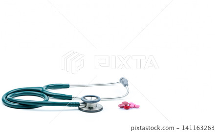 Green stethoscope with tablets pills isolated on white background with copy space. Heartbeat check-up medical tool. Stethoscope of cardiology doctor. Diagnostic medical tool for patient diagnosis. Green stethoscope with tablets pills isolated on white background with copy space. Heartbeat check-up medical tool. Stethoscope of cardiology doctor. Diagnostic medical tool for patient diagnosis. 141163263