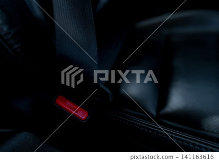 Car seat belt with red press button. Fasten seatbelt for safety and security and protect life from car accident. Buckle up black seat belt for safety. Buckle up seat belt it's the law. Safe road trip. Car seat belt with red press button. Fasten seatbelt for safety and security and protect life from car accident. Buckle up black seat belt for safety. Buckle up seat belt it's the law. Safe road trip. 141163616