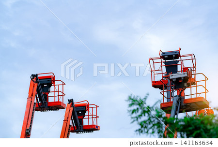 Articulated boom lift. Aerial platform lift. Telescopic boom lift against the sky. Mobile construction crane for rent and sale. Maintenance and repair hydraulic boom lift service. Crane dealership. Articulated boom lift. Aerial platform lift. Telescopic boom lift against the sky. Mobile construction crane for rent and sale. Maintenance and repair hydraulic boom lift service. Crane dealership. 141163634