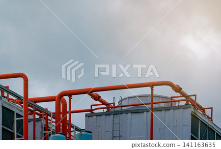 Cooling tower on roof top of building. Industrial air cooling system. Air chiller. Unit of air conditioner. Air cooled chiller with piping system on rooftop of building. Cooling tower outside building Cooling tower on roof top of building. Industrial air cooling system. Air chiller. Unit of air conditioner. Air cooled chiller with piping system on rooftop of building. Cooling tower outside building 141163635