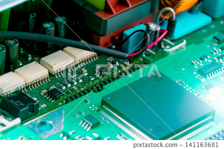 Electronic circuit board. Semiconductor motherboard circuit board technology. Mainboard of computer. Integrated semiconductor microchip on green circuit board. Hi-tech industry and computer science. Electronic circuit board. Semiconductor motherboard circuit board technology. Mainboard of computer. Integrated semiconductor microchip on green circuit board. Hi-tech industry and computer science. 141163681
