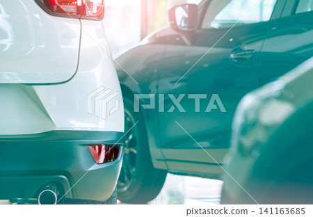 Rearview car parked in luxury showroom. Car dealership office. New car parked in modern showroom. Car for sale and rent business concept. Automobile leasing and insurance concept. Automobile market. 141163685