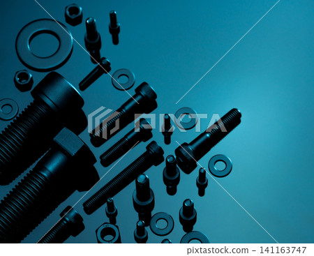 Metal Bolts, nuts, and washers. Fasteners equipment. Hardware tools. Stud bolt, flat washers, hex nuts, and hex head bolts in workshop. Threaded fastener use in automotive engineering. Hexagonal bolt. Metal Bolts, nuts, and washers. Fasteners equipment. Hardware tools. Stud bolt, flat washers, hex nuts, and hex head bolts in workshop. Threaded fastener use in automotive engineering. Hexagonal bolt. 141163747