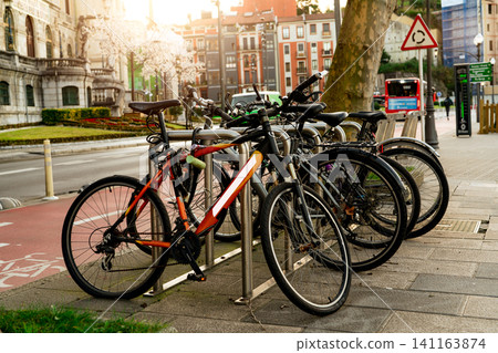 Bicycle at bike station for rent to travel or transport in the city. Sustainable travel. Bicycle sharing system. Bicycle for city tour at bike parking station. Eco-friendly transport. Urban transport. Bicycle at bike station for rent to travel or transport in the city. Sustainable travel. Bicycle sharing system. Bicycle for city tour at bike parking station. Eco-friendly transport. Urban transport. 141163874