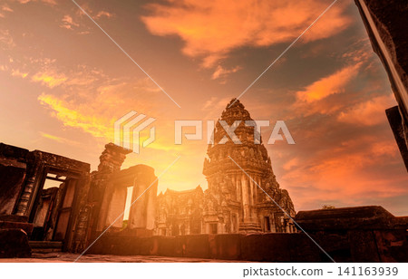Selective focus on Phimai Historical Park with sunset sky. Landmark of Nakhon Ratchasima, Thailand. Travel destinations. Historic site is ancient. Ancient building. Khmer temple classical architecture Selective focus on Phimai Historical Park with sunset sky. Landmark of Nakhon Ratchasima, Thailand. Travel destinations. Historic site is ancient. Ancient building. Khmer temple classical architecture 141163939