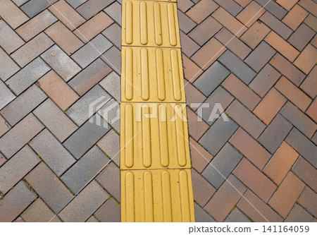 Braille blocks laid on the sidewalk Braille blocks laid on the sidewalk 141164059