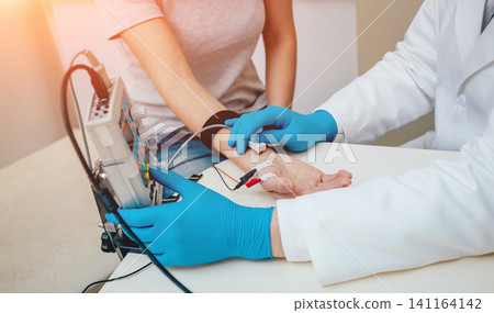 Patient nerves testing using electromyography. EMG Patient nerves testing using electromyography. EMG 141164142