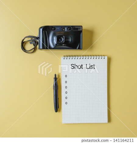 Film camera with spiral notebook for shot list and pen. Film camera with spiral notebook for shot list and pen. 141164211