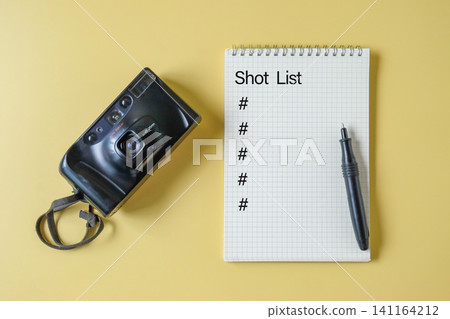Film camera with spiral notebook for shot list and pen. Film camera with spiral notebook for shot list and pen. 141164212