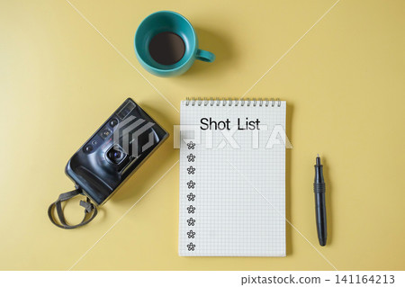 Film camera with spiral notebook for shot list and pen. Film camera with spiral notebook for shot list and pen. 141164213