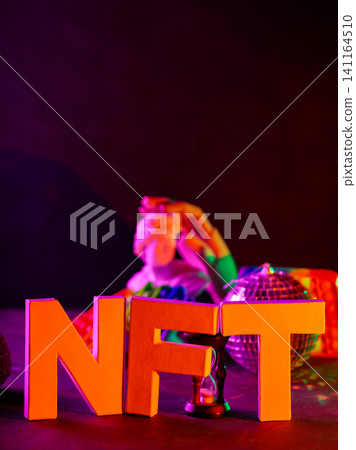 Bold NFT letters with classical sculpture and disco ball in vibrant neon lighting Bold NFT letters with classical sculpture and disco ball in vibrant neon lighting 141164510