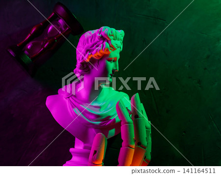 Classical marble statue with hourglass and an artificial hand illuminated by vibrant neon gradient lighting Classical marble statue with hourglass and an artificial hand illuminated by vibrant neon gradient lighting 141164511
