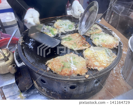 在台中的夜市拍攝攤販熟練地製作蚵仔煎 在台中的夜市拍攝攤販熟練地製作蚵仔煎 141164729