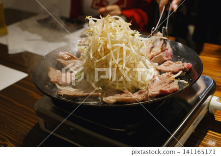 Genghis Khan (lamb barbecue) cooked in a special pot. Genghis Khan (lamb barbecue) cooked in a special pot. 141165171