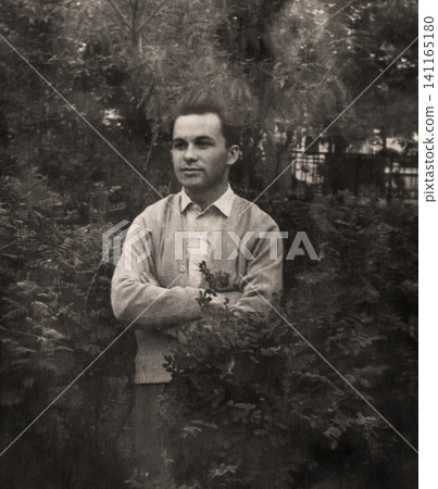 Young Soviet Man Standing Outdoors in a Garden in 1959 Young Soviet Man Standing Outdoors in a Garden in 1959 141165180