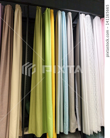 A range of colorful curtains displayed in a retail store, showcasing various designs A range of colorful curtains displayed in a retail store, showcasing various designs 141165665
