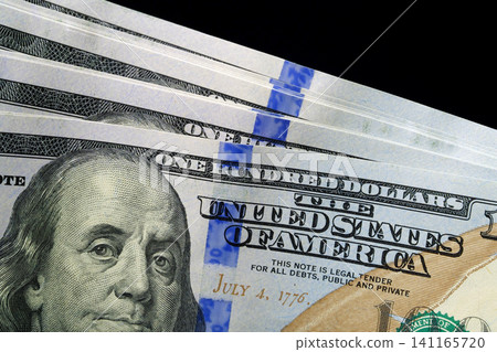 Close-up of fresh hundred-dollar bills, symbolizing wealth and savings Close-up of fresh hundred-dollar bills, symbolizing wealth and savings 141165720