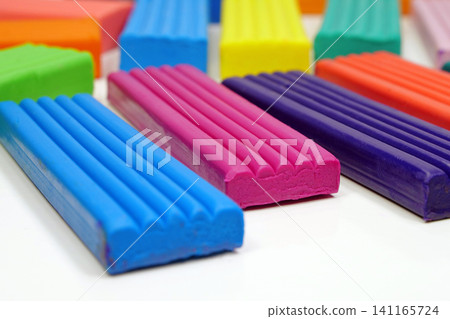 Bright plasticine ready for shaping and modeling fun. Colorful plasticine pieces ready for creative play 141165724
