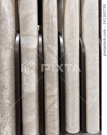 A stylish assortment of wallpaper rolls in a range of patterns, colors, and textures, perfect for updating any space with a modern touch 141165739