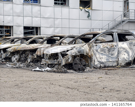 Burnt cars left in a parking lot after a fire Burnt cars left in a parking lot after a fire 141165764