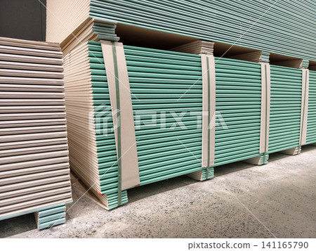 A supply warehouse organized with stacks of gypsum boards ready for distribution A supply warehouse organized with stacks of gypsum boards ready for distribution 141165790