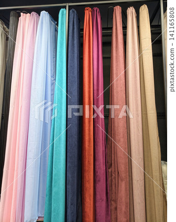 Fabric curtains in multiple designs and colors displayed on racks Fabric curtains in multiple designs and colors displayed on racks 141165808