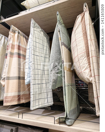 Soft pillows on display in home showroom offering bedding variety Soft pillows on display in home showroom offering bedding variety 141165809
