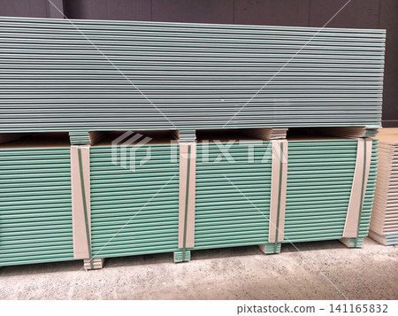 Plenty of stacked gypsum boards in a construction supply warehouse Plenty of stacked gypsum boards in a construction supply warehouse 141165832