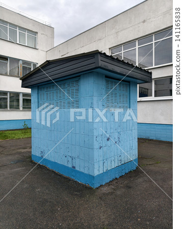 Blue concrete ventilation building near a Soviet school campus, highlighting essential engineering components of institutional facilities Blue concrete ventilation building near a Soviet school campus, highlighting essential engineering components of institutional facilities 141165838