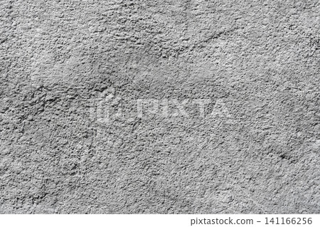 Closeup grainy gray surface texture with rough granular detail, minimal abstract background Closeup grainy gray surface texture with rough granular detail, minimal abstract background 141166256