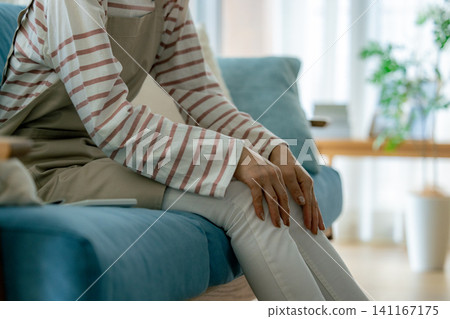 A woman complaining of knee pain A woman complaining of knee pain 141167175