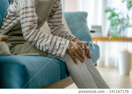 A woman complaining of knee pain A woman complaining of knee pain 141167176
