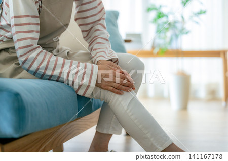 A woman complaining of knee pain A woman complaining of knee pain 141167178