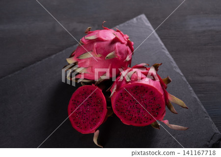 Dragon fruit on a grey granite background Dragon fruit on a grey granite background 141167718