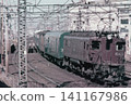 An express train pulled by an EF57 electric locomotive running near Nishi-Nippori Station during the Japanese National Railways era. 141167986