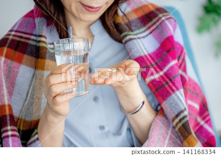 Woman taking medicine Woman taking medicine 141168334