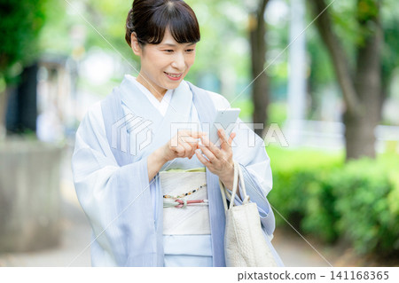 A woman in a kimono A woman in a kimono 141168365