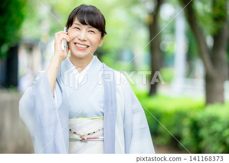 A woman in a kimono A woman in a kimono 141168373