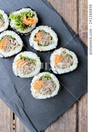 Korean seaweed rolls on a slate plate: Bulgogi Kimbap Korean seaweed rolls on a slate plate: Bulgogi Kimbap 141168856