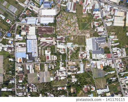Vertical top-down aerial drone view of a mixed-use landscape with factories, farmland, and residential areas in Cu Chi District, Ho Chi Minh City 141170115