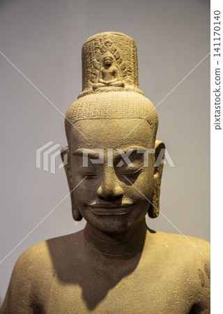 Close-up museum photo of an ancient stone Buddha statue with a peaceful face and detailed carved features Close-up museum photo of an ancient stone Buddha statue with a peaceful face and detailed carved features 141170140