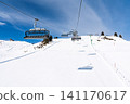 Ski lift over snowy mountain slopes in Saalbach Austria on a bright sunny winter day in Alps 141170617
