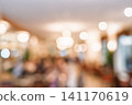Blurred restaurant interior with warm bokeh lights for a cozy and inviting background design 141170619